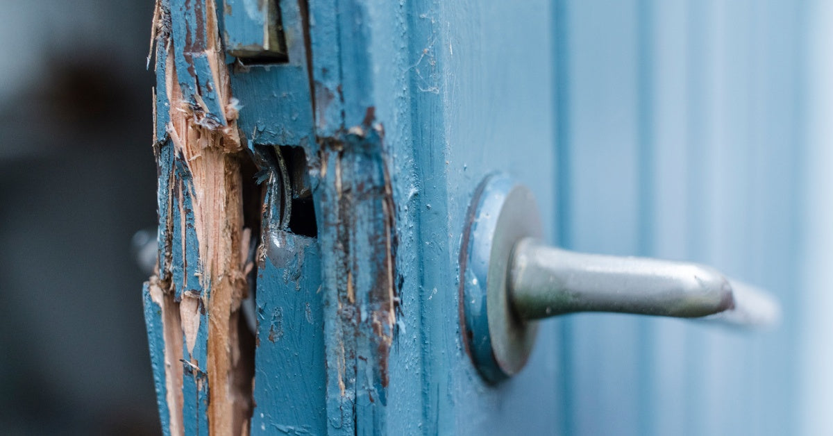 The door is broken near the handle, creating wood splinters.
